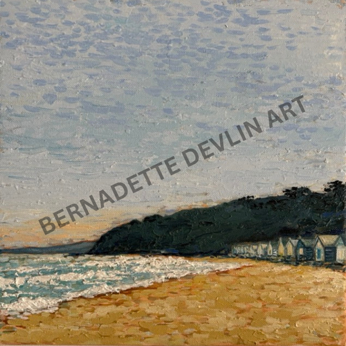 Painting of a beach scene with houses and a cliff, signed 'Bernadette Devlin Art'.